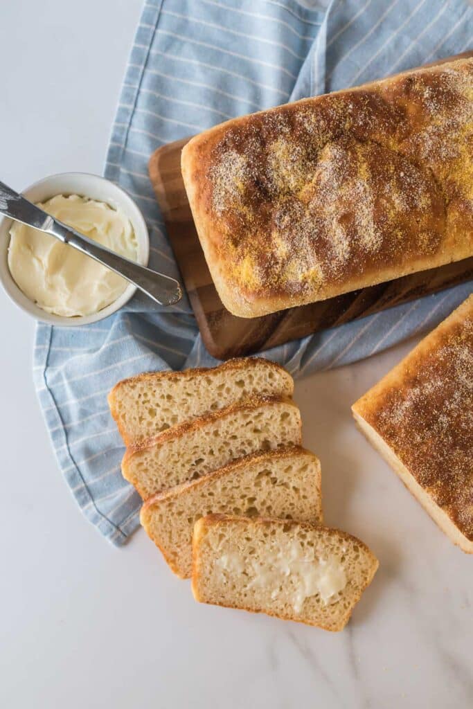 loaf of English muffin bread sliced and top slice buttered