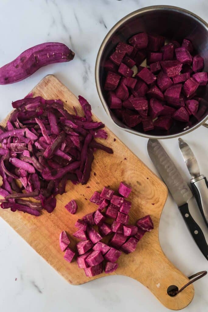 purple sweet potatoes being peeled and diced
