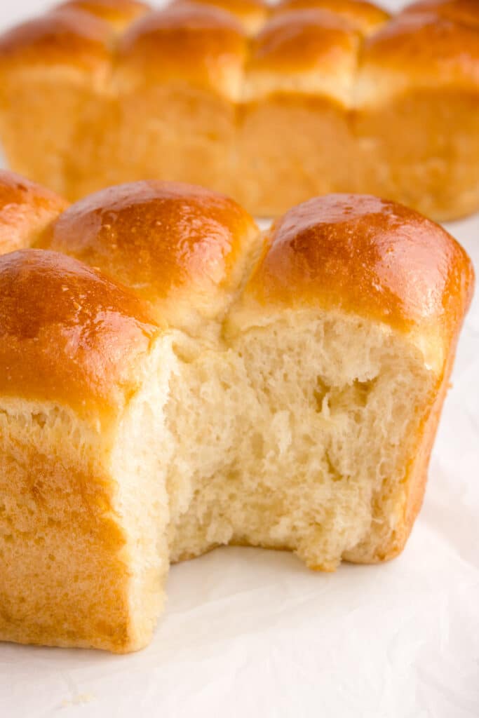 brioche with piece removed to show inside texture