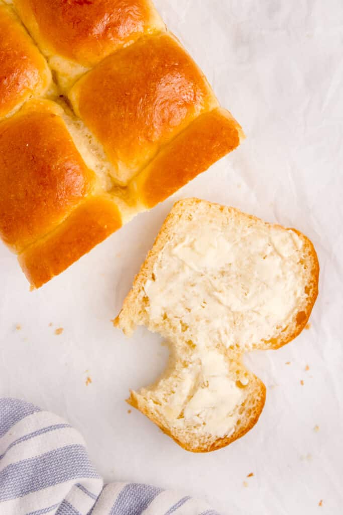 loaf of brioche beside slice with bite taken out