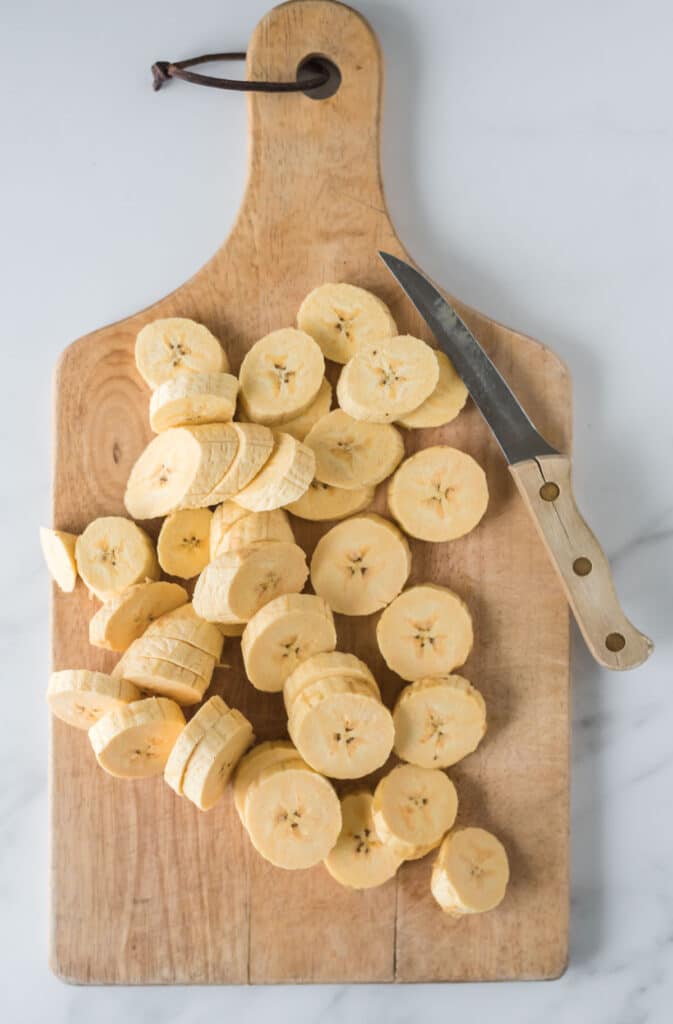 cutting board with sliced plantains