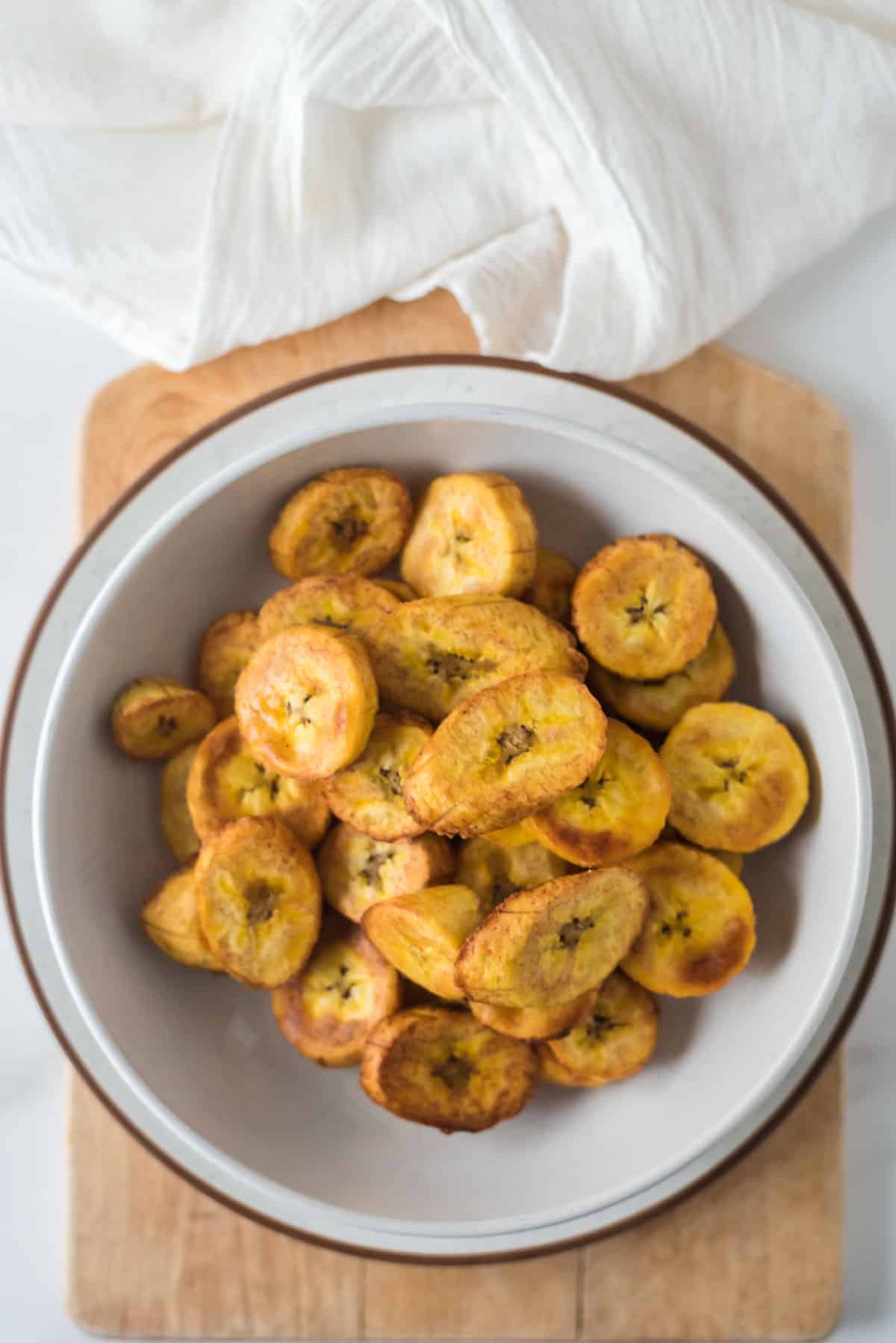 white bowl filled with fried plantain slices