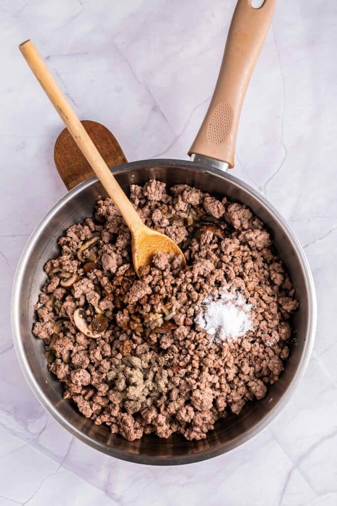 pan with cooked ground beef and onions and mushrooms