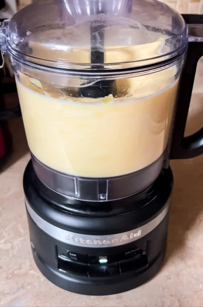 pineapple being pureed in food processor