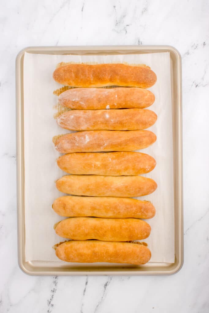 freshly baked breadsticks on rimmed baking sheet