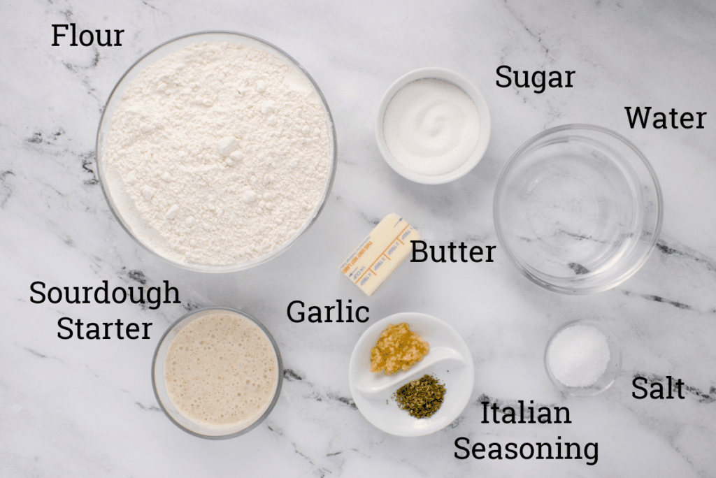 ingredients for sourdough breadsticks in glass jars with text overlay labels