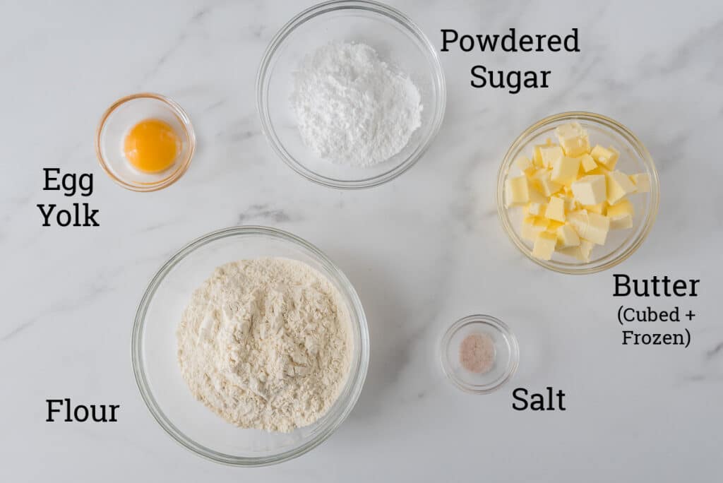 ingredients for shortbread crust in glass bowls with text overlays of names