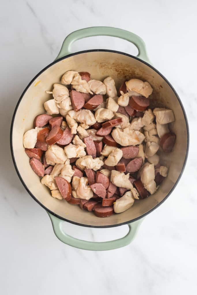 dutch oven with sautéed chicken and sausage