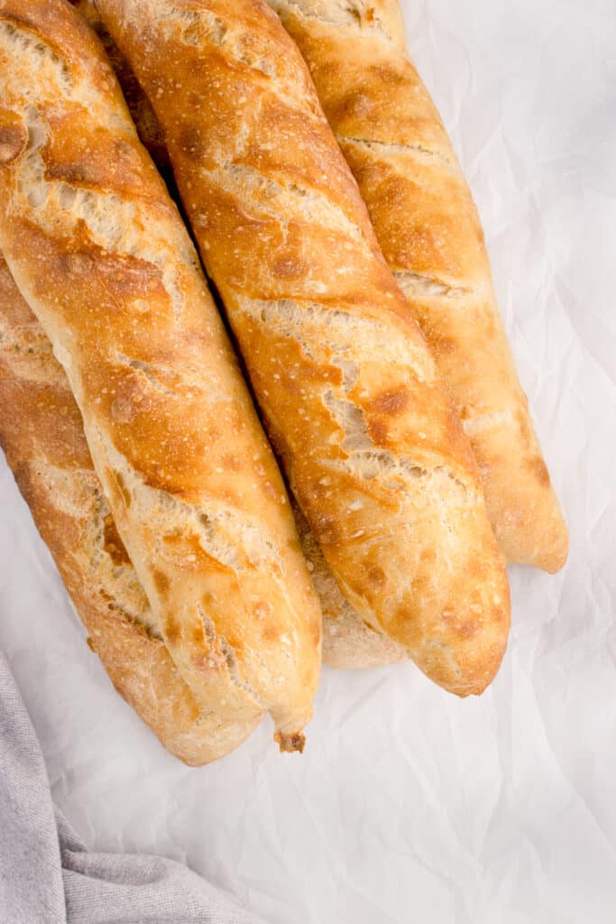 four baguette loaves stacked on top of each other at a diagonal