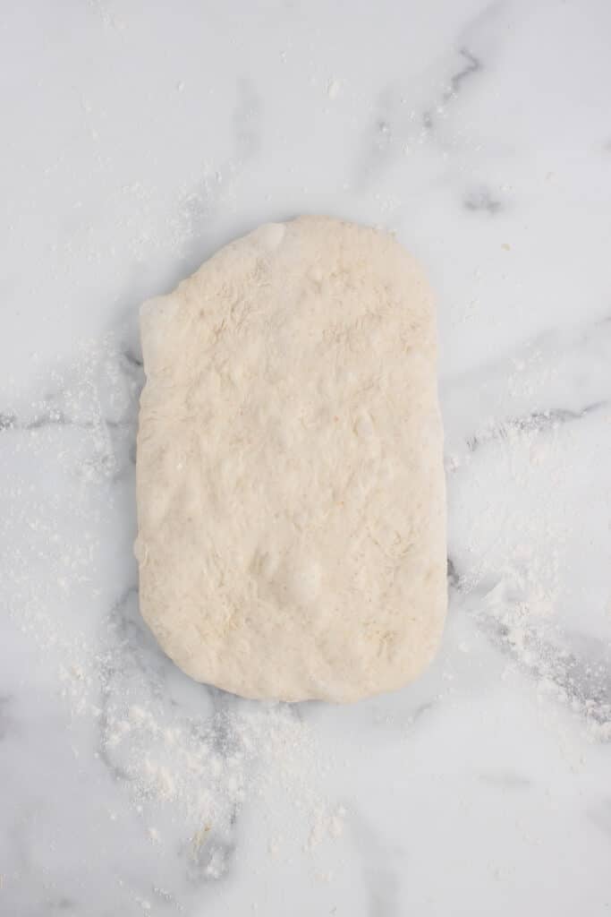 ball of dough flattened into rectangle 