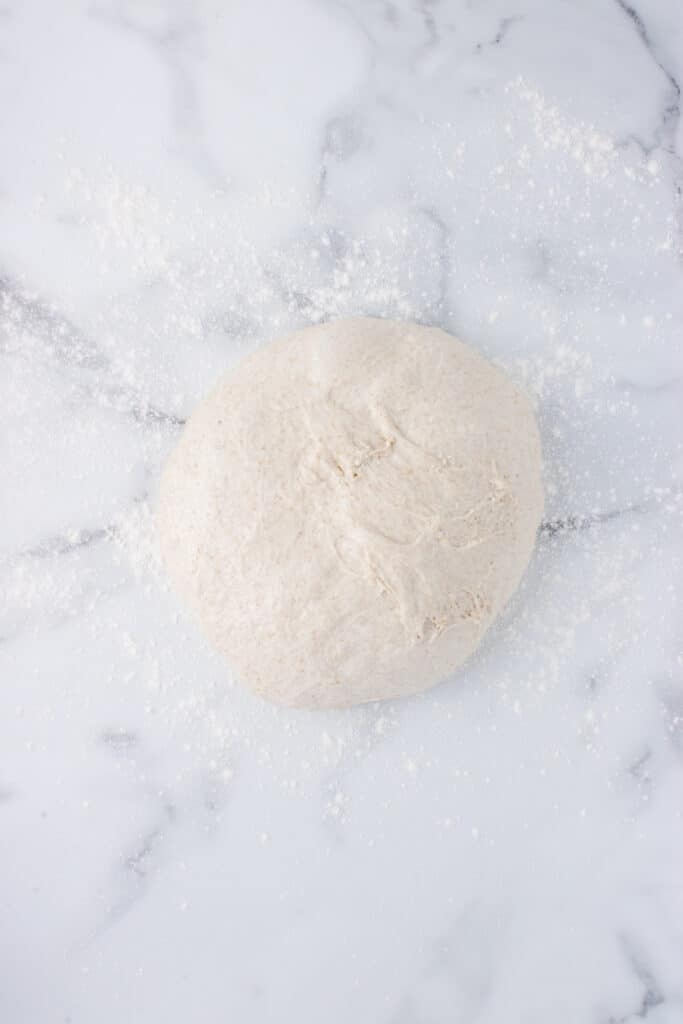 round ball of dough on marble 