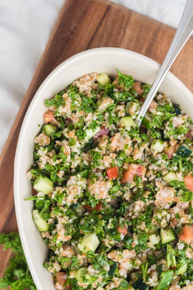 tabbouleh salad in white serving dish with spoon