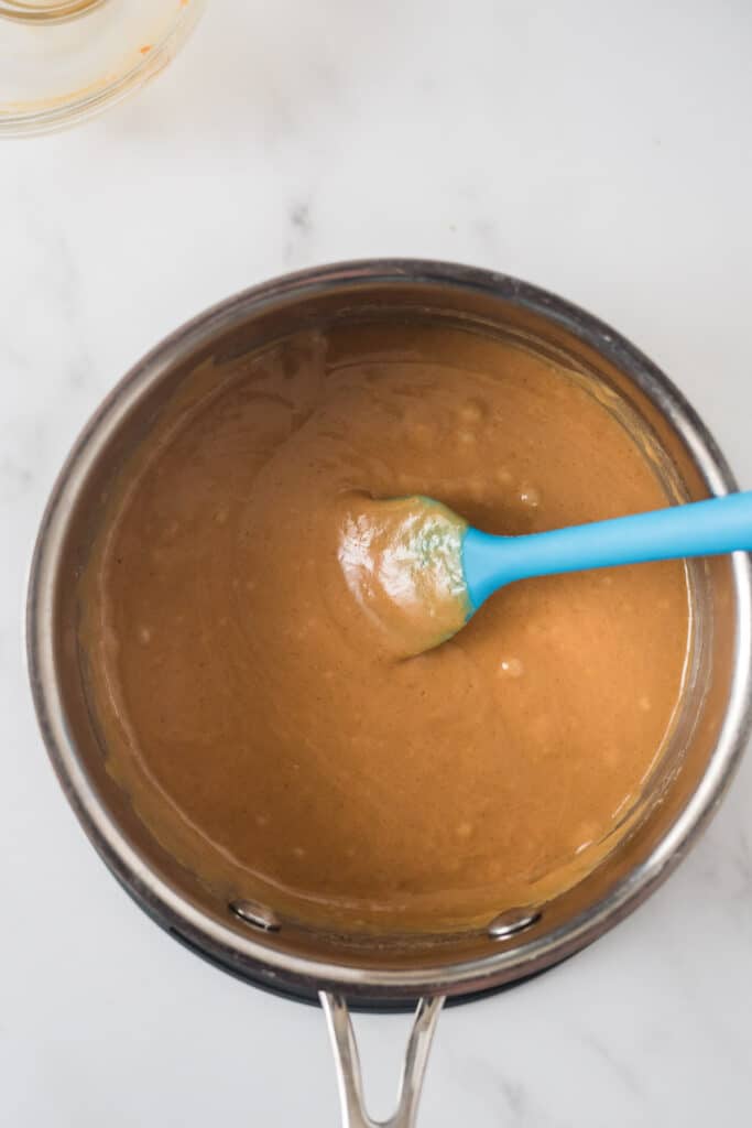 small saucepan with mixed peanut butter sauce for popcrn
