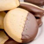 sourdough shortbread cookies dipped in chocolate on white platter