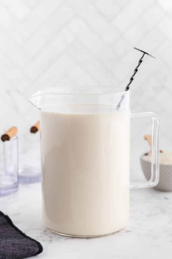 pitcher mixing together horchata ingredients 