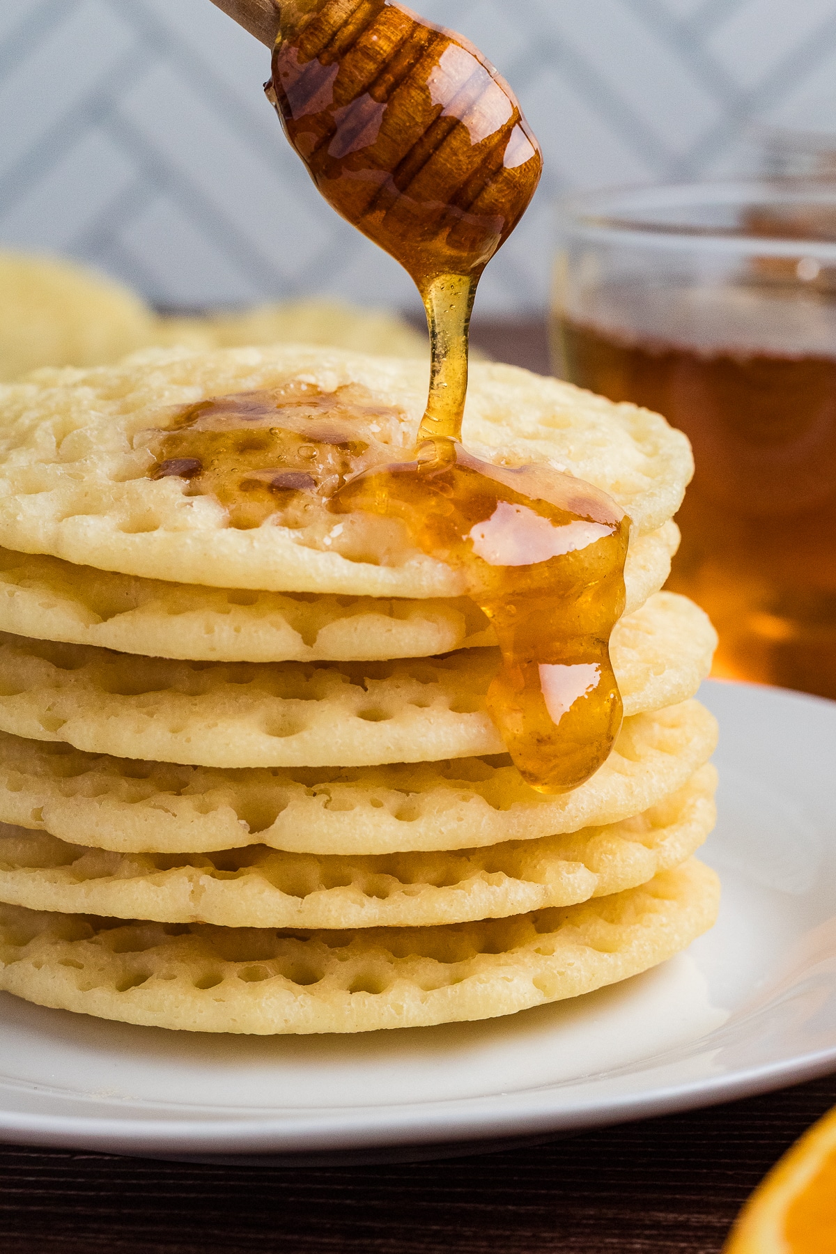 stack of moroccan pancakes with honey being drizzled on top