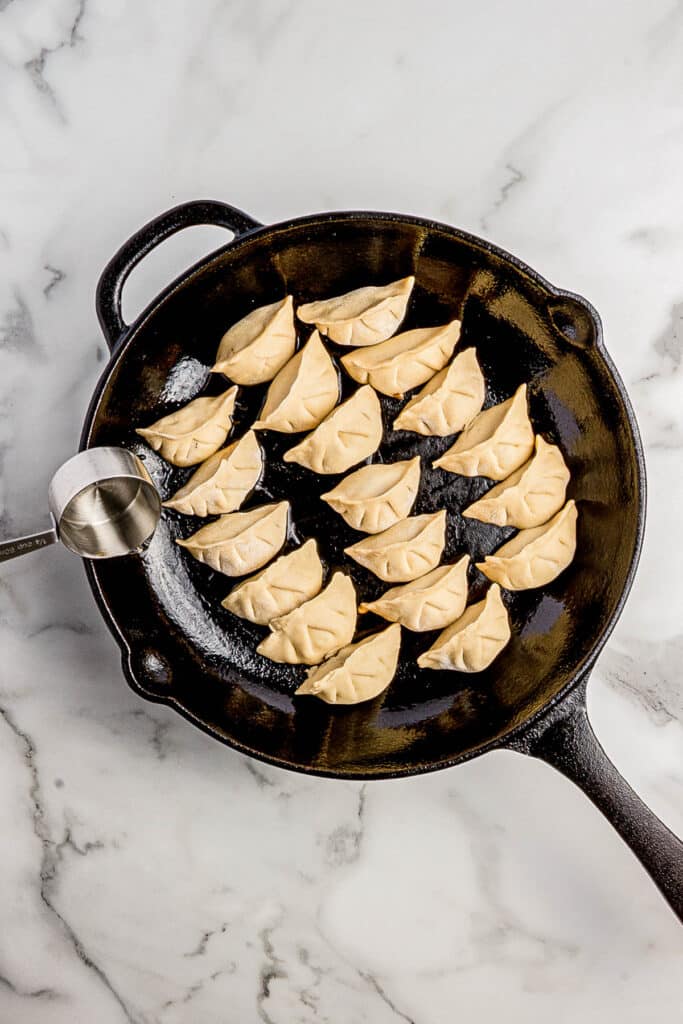 cooking dumplings in cast iron skillet with water