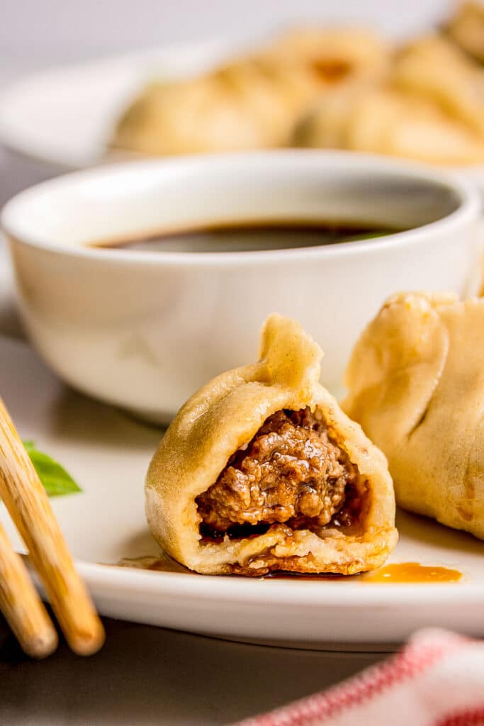 asian dumpling cut in half to show ginger beef filling
