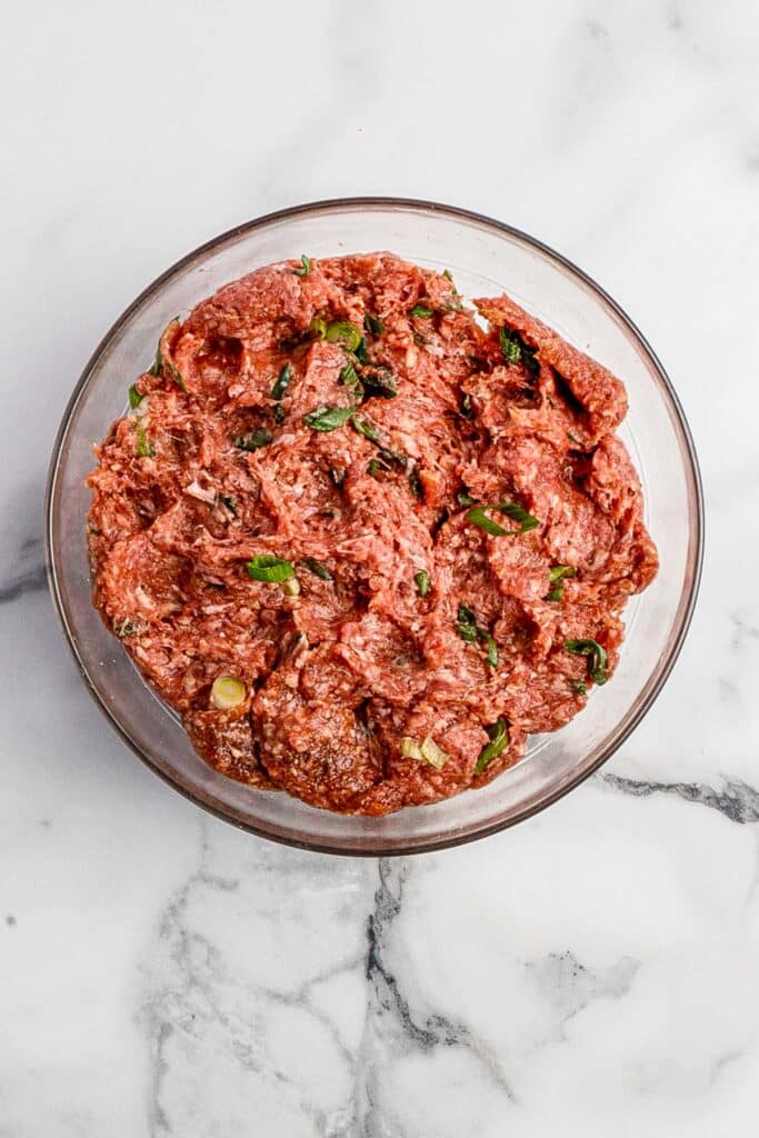 glass bowl with ginger ground beef dumpling filling all mixed together