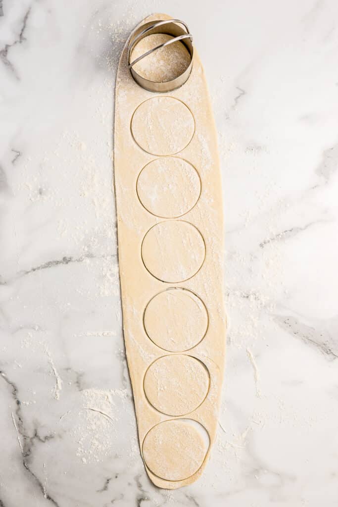 dough rolled into rectangle with circles cut into it