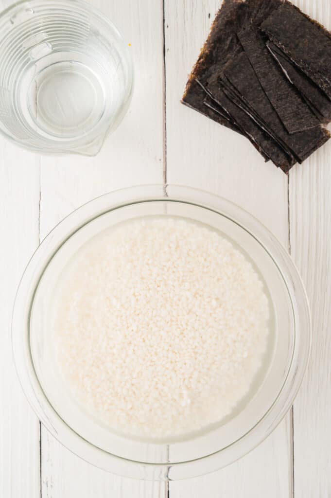 rice soaking in glass bowl
